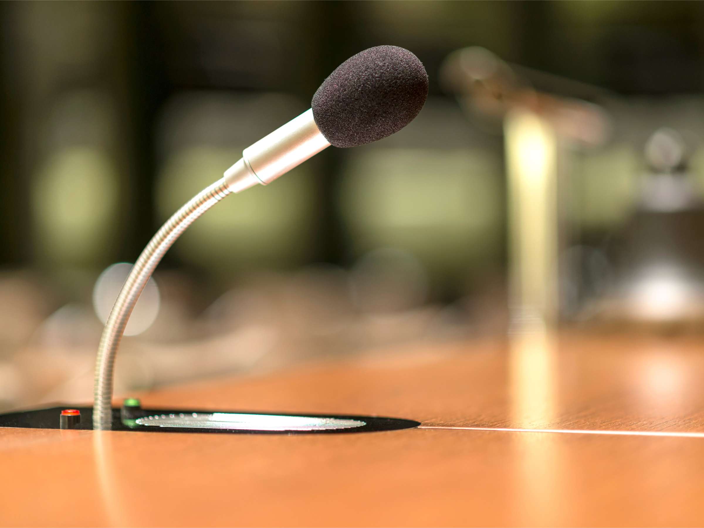 Isolated view of a microphone in a conference room.png
